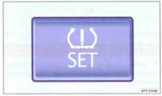 Dans la console centrale : touche de réglage de l'indicateur de contrôle des pneus.
